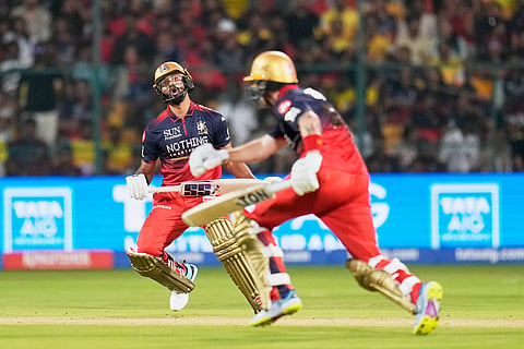 Royal Challengers Bengaluru's Devdutt Padikkal, left, reacts after failing to take a run between the wickets with batting partner Phil Salt during the Indian Premier League cricket match between Chennai Super Kings and Royal Challengers Bengaluru in Bengaluru, India.