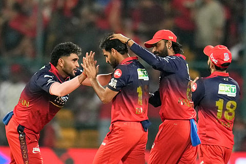 Royal Challengers Bengaluru's Bhuvneshwar Kumar, second left, celebrates with teammates the wicket of Chennai Super Kings' Ayush Mhatre during the Indian Premier League cricket match between Chennai Super Kings and Royal Challengers Bengaluru in Bengaluru, India.