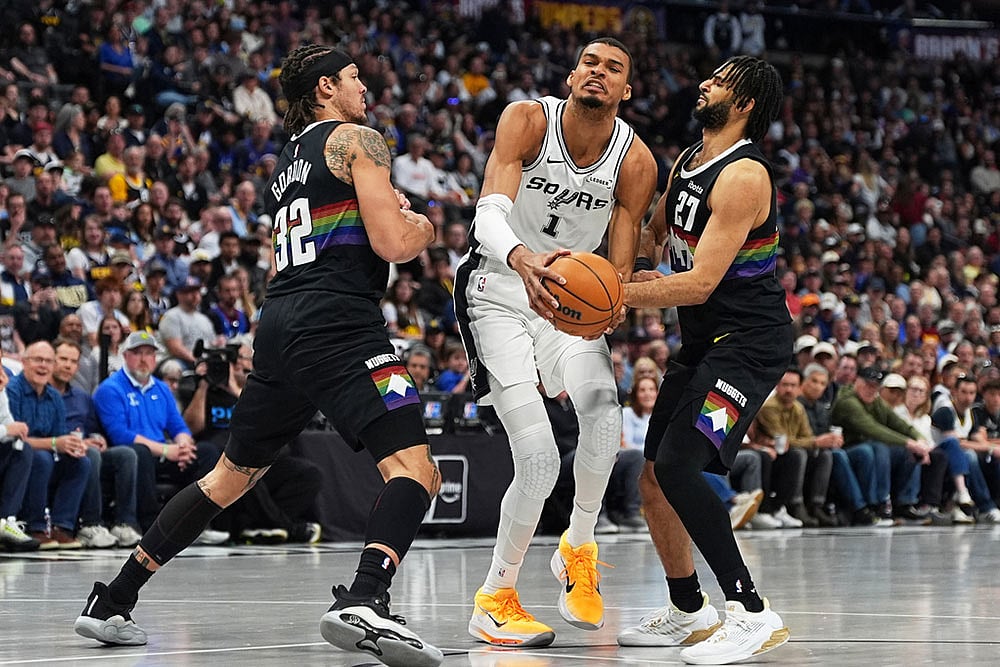 | Photo: AP/David Zalubowski : San Antonio Spurs center Victor Wembanyama is fouled by Denver Nuggets guard Jamal Murray, right, while driving past forward Aaron Gordon in the first half of an NBA basketball game in Denver.