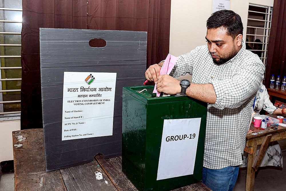 A voter casts his postal ballot at a facilitation centre for the Assam Legislative Assembly elections ahead of the April 9 polling date, in Guwahati. - | Photo: PTI