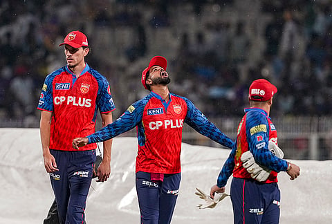 Punjab Kings' captain Shreyas Iyer, centre, reacts during rain interruption in an Indian Premier League (IPL) 2026 cricket match between Kolkata Knight Riders and Punjab Kings at Eden Gardens, in Kolkata.