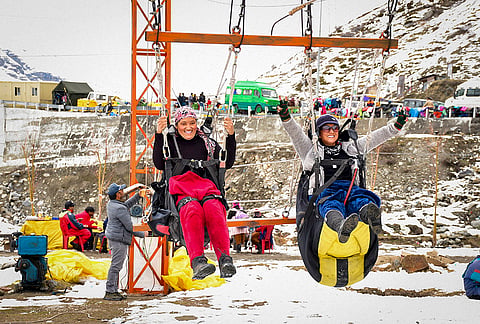 Tourists take part in adventure activities amid snow at the North Portal of Atal Tunnel, Rohtang, in Lahaul-Spiti district of Himachal Pradesh.
