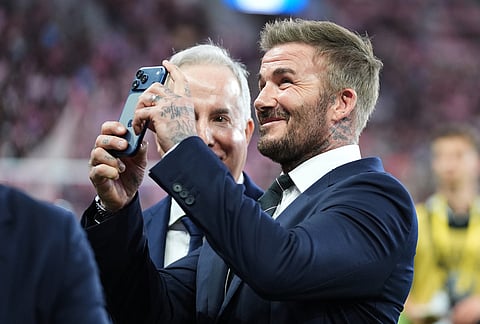 Inter Miami CF co-owner David Beckham takes a photograph before an MLS soccer match against Austin FC, in Miami. 