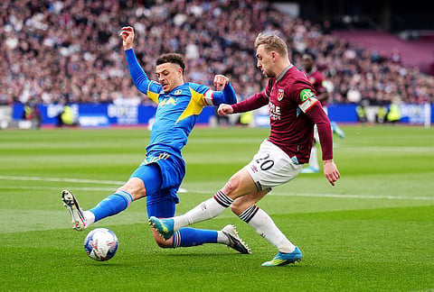 West Ham United's Jarrod Bowen, right, and Leeds United's Ethan Ampadu in action during the English FA Cup quarterfinal soccer match between West Ham United and Leeds United in London.