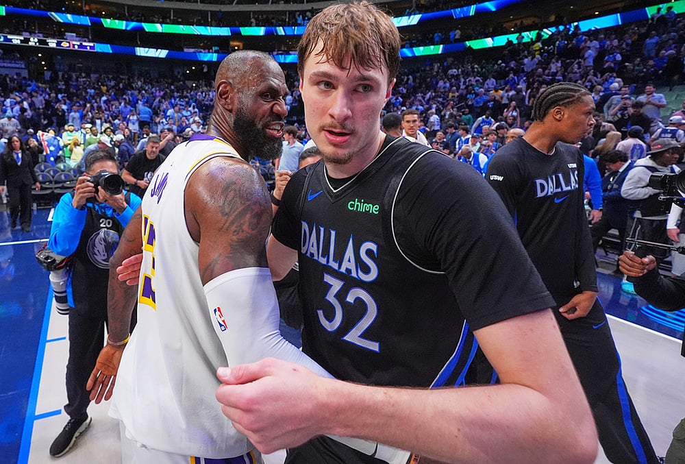 Dallas Mavericks forward Cooper Flagg (32) and Los Angeles Lakers forward LeBron James (23) hug at the end of their NBA basketball game in Dallas. - | Photo: AP/LM Otero