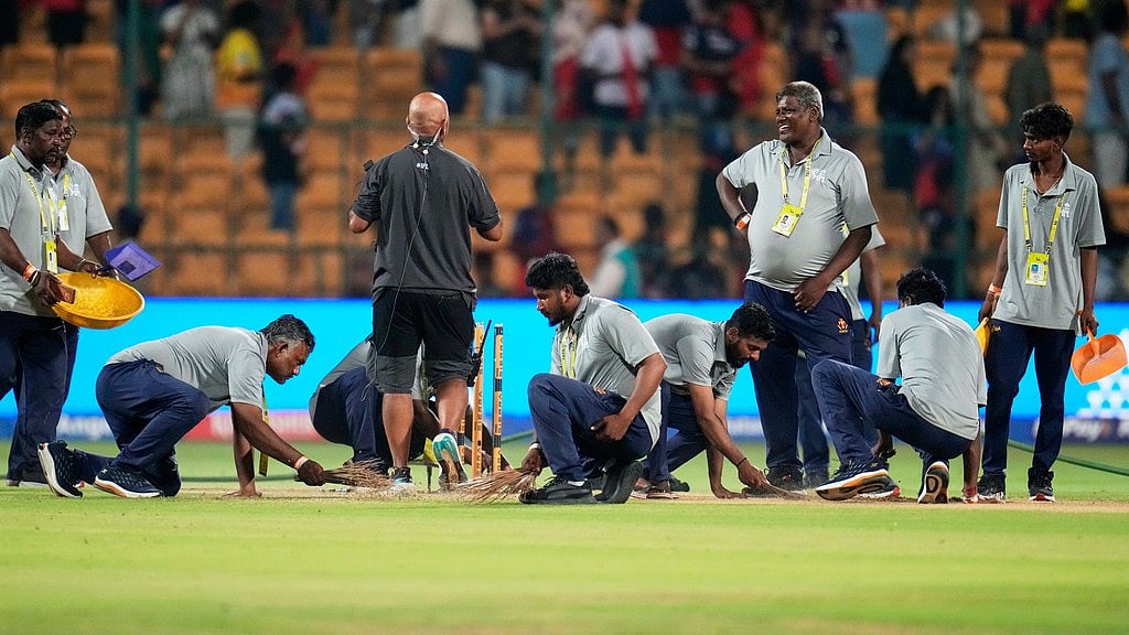 AP : Groundsmen clean the playing surface after Royal Challengers Bengaluru won their Indian Premier League cricket match against Chennai Super Kings in Bengaluru.