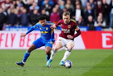 West Ham United's Jarrod Bowen, right, and Leeds United's James Justin battle for the ball during their English FA Cup, quarter-final soccer match in London.