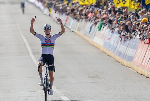 Slovenia's Tadej Pogacar crosses the finish line to win the Tour of Flanders cycling race, in Oudenaarde, Belgium.