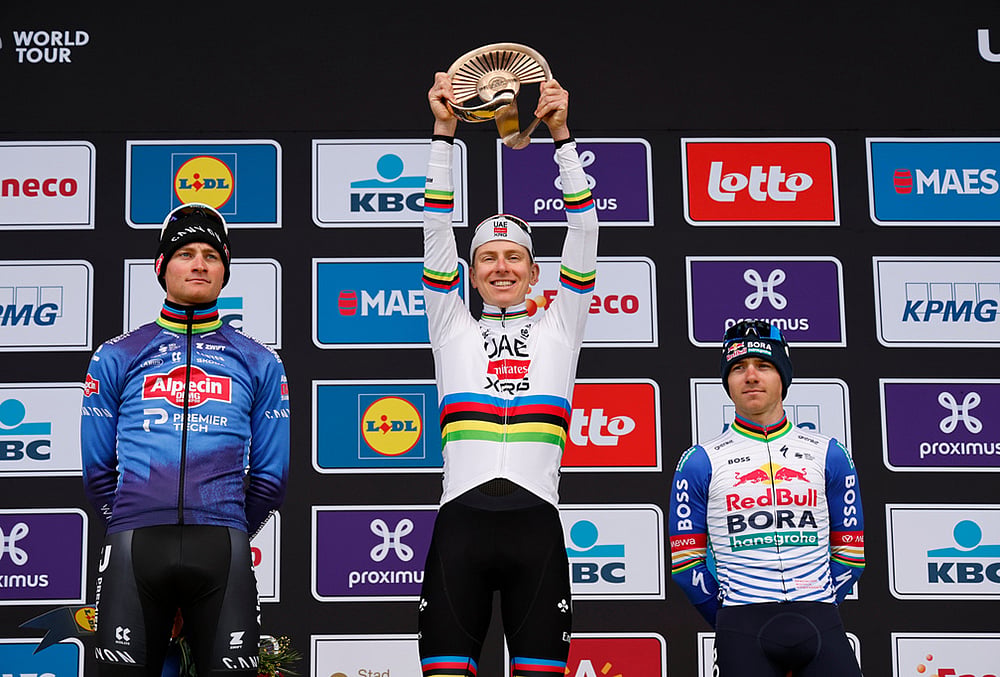 Slovenia's Tadej Pogacar celebrates after winning the Tour of Flanders cycling race, with Netherland's Mathieu Van Der Poel, left, finishing second and Belgium's Remco Evenpoel third in Oudenaarde, Belgium. - | Photo: AP/Geert Vanden Wijngaert