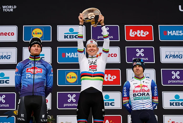 Slovenia's Tadej Pogacar celebrates after winning the Tour of Flanders cycling race, with Netherland's Mathieu Van Der Poel, left, finishing second and Belgium's Remco Evenpoel third in Oudenaarde, Belgium. - | Photo: AP/Geert Vanden Wijngaert