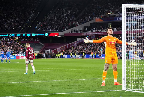 Leeds United goalkeeper Lucas Perri, right, celebrates saving West Ham United's Jarrod Bowen penalty in the shoot-out during the English FA Cup quarterfinal soccer match between West Ham United and Leeds United, in London.