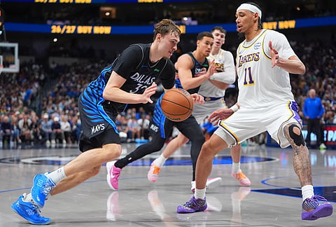 Dallas Mavericks forward Cooper Flagg (32) dribbles against Los Angeles Lakers defender Jaxson Hayes (11) during the second half of an NBA basketball game in Dallas.