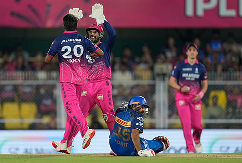 Rajasthan Royals' Sandeep Sharma celebrates with Dhruv Jurel the wicket of Mumbai Indians' Rohit Sharma during the Indian Premier League cricket match between Mumbai Indians and Rajasthan Royals in Guwahati.