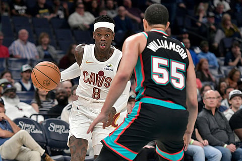 Cleveland Cavaliers guard Dennis Schroder (8) handles the ball against Memphis Grizzlies guard Lucas Williamson (55) in the first half of an NBA basketball game in Memphis, Tenn. 