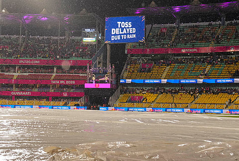 View of the ground covered due to rain as a screen displays 'Toss delayed due to rain' during an Indian Premier League (IPL) 2026 T20 cricket match between Rajasthan Royals and Mumbai Indians, in Guwahati.