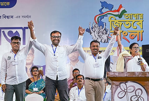 West Bengal Chief Minister Mamata Banerjee, right, joins hands with TMC candidates for Chakdaha, Kalyani and Haringhata constituencies, Subhankar Singha, left, Dr. Atindra Nath Mondal, second right, and Dr. Rajib Biswas, second left, respectively, during a public rally in support of the candidates ahead of the state assembly elections, in Nadia district.