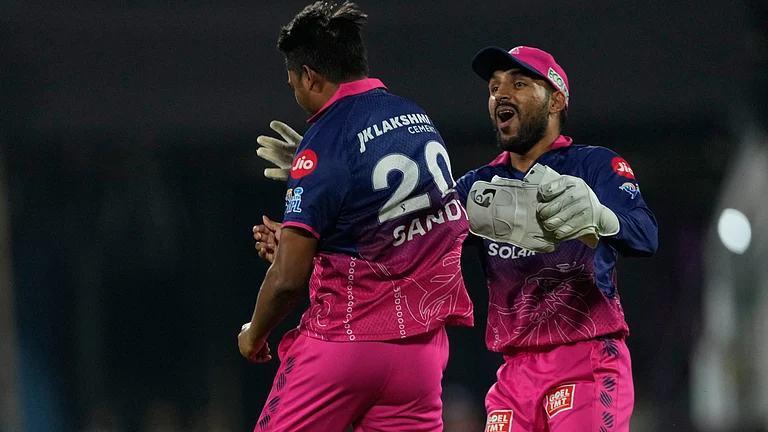 Rajasthan Royals' Sandeep Sharma, left, celebrates with Dhruv Jurel after takes the catch to dismiss Mumbai Indians' Shefane Rutherford during the Indian Premier League cricket match between Mumbai Indians and Rajasthan Royals in Guwahati, India, Wednesday, April 8, 2026. - AP Photo
