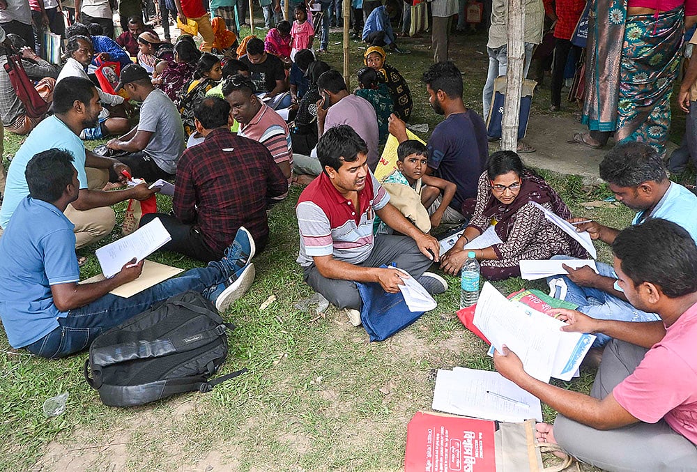| Photo: PTI : People, whose names were deleted from voters' lists in the ongoing Special Intensive Revision (SIR) of electoral rolls in poll-bound West Bengal, queue up to present their cases before judicial officers, ahead of the state Assembly elections, at Krishnanagar, in Nadia district.