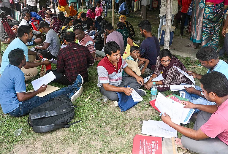 People, whose names were deleted from voters' lists in the ongoing Special Intensive Revision (SIR) of electoral rolls in poll-bound West Bengal, queue up to present their cases before judicial officers, ahead of the state Assembly elections, at Krishnanagar, in Nadia district. - | Photo: PTI