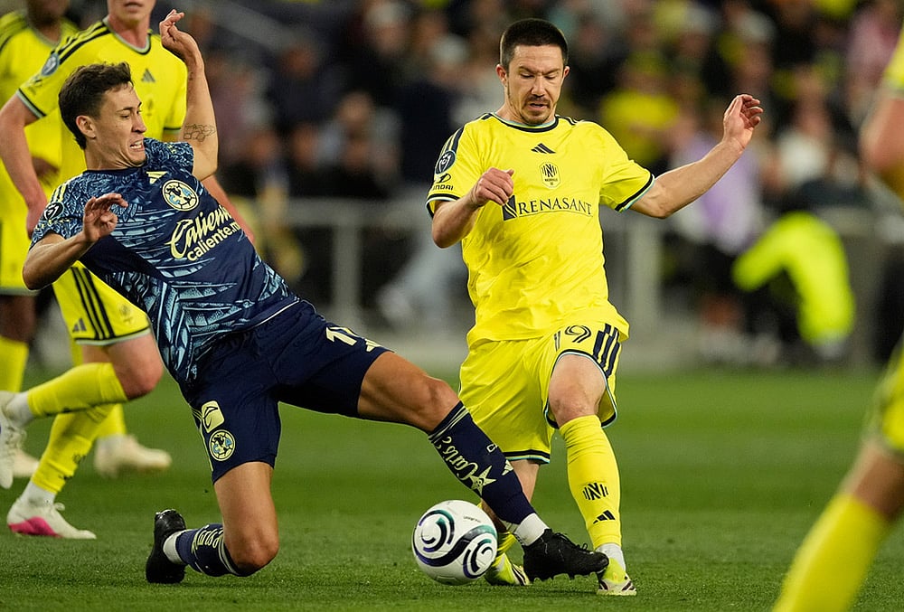 Nashville SC midfielder Alex Muyl (19) kicks the ball past Club America midfielder Rodrigo Dourado, left, during the second half of an CONCACAF Champions Cup first leg quarterfinal soccer match in Nashville, Tennessee.  - | Photo: AP/George Walker IV