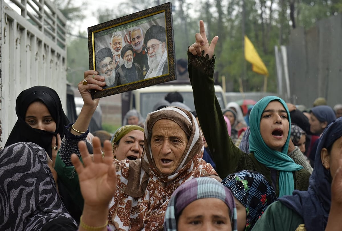 People raise slogans and hold a portrait of late Iran's Supreme Leader Ayatollah Ali Khamenei, in response to the ceasefire agreement between Iran, the United States and Israel, after US President Donald Trump pulled back from his threats to destroy Iranian civilization, in Srinagar, Jammu and Kashmir, Wednesday, April 8, 2026 - Yasir Iqbal