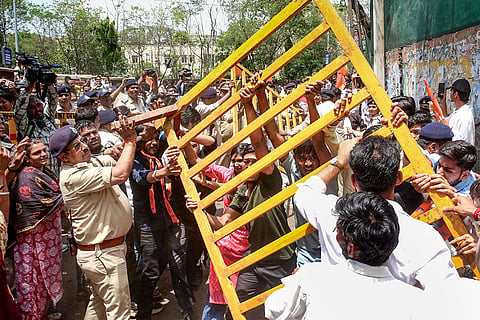 Police stop Akhil Bharatiya Vidyarthi Parishad (ABVP) members as they stage a protest demanding the removal of liquor shops located near educational institutions, in Bhopal.