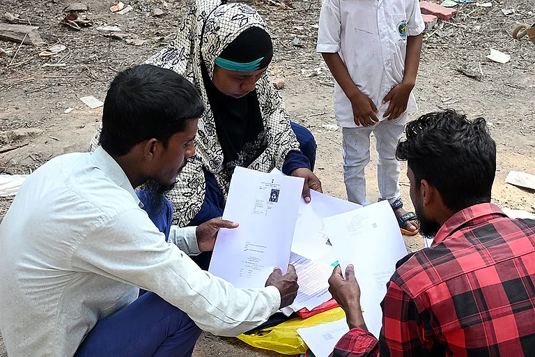 People wait to submit their petitions before the Special Tribunal after their names were deleted from the Special Intensive Revision final voter list ahead of West Bengal Assembly Election, at Ranaghat, in Nadia district. - | Photo: PTI