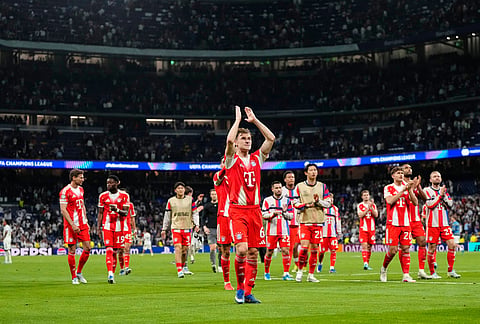 Bayern players with Joshua Kimmich, center, greet fans after the Champions League quarterfinal first leg soccer match between Real Madrid and Bayern Munich in Madrid, Spain.