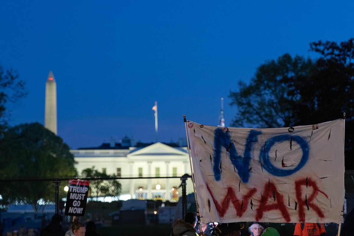 Activists protest at Lafayette Park near the White House in Washington, Tuesday evening, April 7, 2026.  - AP Photo/Jose Luis Magana