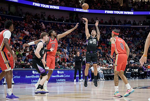 Utah Jazz guard John Konchar (55) shoots against New Orleans Pelicans forward Kevon Looney (55) during the first half of an NBA basketball game in New Orleans.