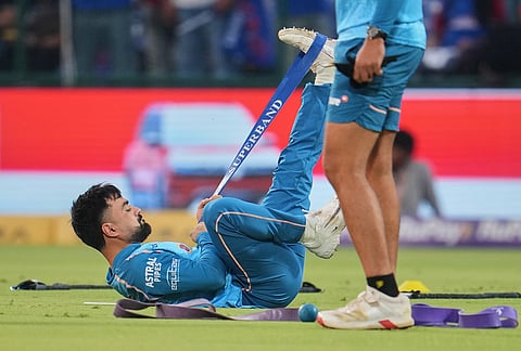 Gujarat Titans' Rashid Khan warms up before the start of the Indian Premier League cricket match between Delhi Capitals and Gujarat Titans in New Delhi.