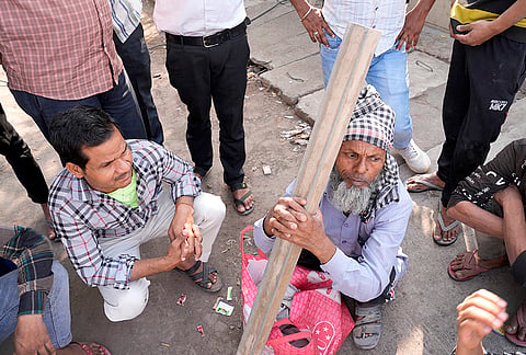 Hundreds gather everyday at the market in a loose sprawl. They stand beside open stretches where refuse floated in a nearby drain, stirred by SUVs that honked for space as people in cars entered the factory against whose wall the labourers leaned.