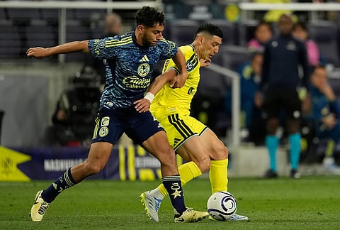 Club America defender Sebastian Caceres, left, and Nashville SC forward Cristian Espinoza, right, battle for the ball during the second half of an CONCACAF Champions Cup first leg quarterfinal soccer match in Nashville, Tennessee.