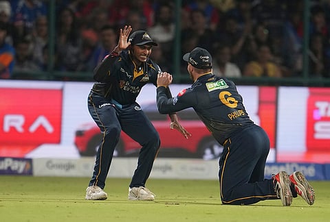 Gujarat Titans' Glenn Phillips, right, celebrates after taking catch to dismiss Delhi Capitals' captain Axar Patel during the Indian Premier League cricket match between Delhi Capitals and Gujarat Titans in New Delhi.