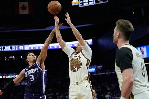 Golden State Warriors guard Seth Curry (31) shoots a 3-point basket over Sacramento Kings guard Killian Hayes (3) during the second half of an NBA basketball game in San Francisco.