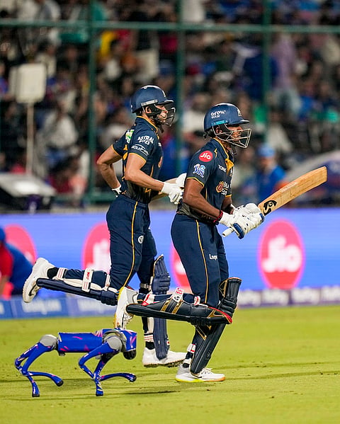 Gujarat Titans' captain Shubman Gill, left, and Sai Sudharsan enter the field ahead of an Indian Premier League (IPL) 2026 T20 cricket match between Delhi Capitals and Gujarat Titans, at Arun Jaitley Stadium, in New Delhi.