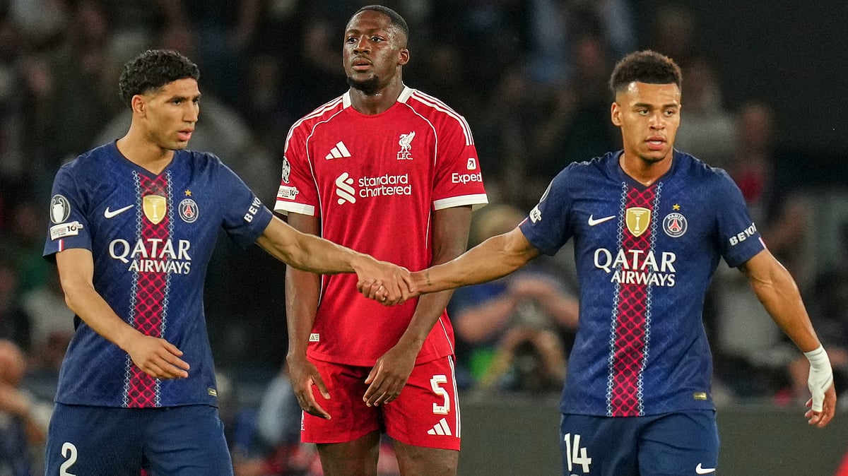 Aurelien Morissard/AP : Liverpool's Ibrahima Konate looks on as PSG's Desire Doue, right, is greeted by Achraf Hakimi after scoring his side's opening goal.