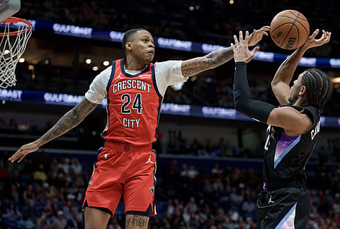 New Orleans Pelicans guard Jordan Hawkins (24) blocks the shot of Utah Jazz guard Kennedy Chandler (0) during the first half of an NBA basketball game in New Orleans.