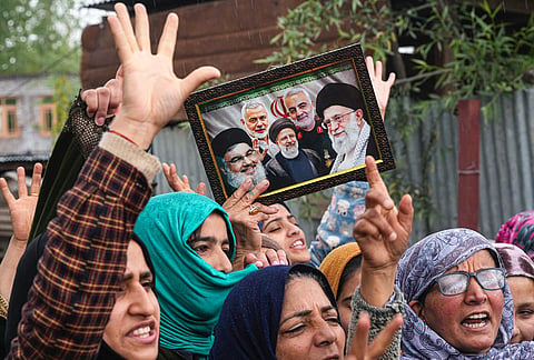 People raise slogans and hold a portrait of late Iran's Supreme Leader Ayatollah Ali Khamenei, in response to the ceasefire agreement between Iran, the United States and Israel, after US President Donald Trump pulled back from his threats to destroy Iranian civilization, in Srinagar, Jammu and Kashmir.