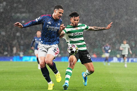 Arsenal's William Saliba, left, challenges Sporting's Luis Suarez during the Champions League quarterfinals, first leg, soccer match between Sporting CP and Arsenal, in Lisbon.