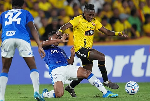 Bryan Carabali of Ecuador's Barcelona, right, fights the ball with Kaiki Bruno of Brazil's Cruzeiro during a Copa Libertadores Group D soccer match in Guayaquil, Ecuador.
