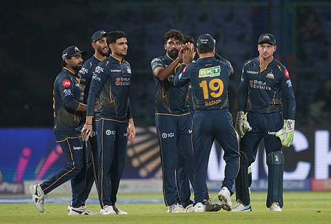 Gujarat Titans' Mohammed Siraj, centre, celebrates with teammates the wicket of Delhi Capitals' KL Rahul during the Indian Premier League cricket match between Delhi Capitals and Gujarat Titans in New Delhi.