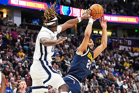 Denver Nuggets guard Jamal Murray, right, goes up for a basket as Memphis Grizzlies guard Jahmai Mashack defends in the second half of an NBA basketball game in Denver.