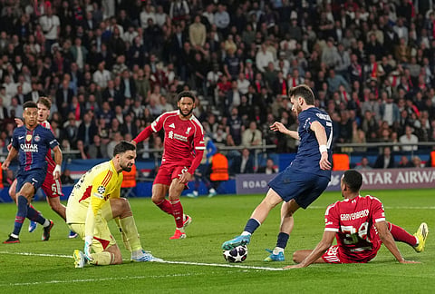 PSG's Khvicha Kvaratskhelia makes his way through on his way to score his side's second goal during the Champions League quarterfinal first leg soccer match between Paris Saint-Germain and Liverpool in Paris.