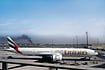 | Photo: AP : Enveloped by Darkness: A plume of smoke caused by an Iranian strike is seen in the background of an Emirates plane parked at the Dubai International Airport on March 1, 2026