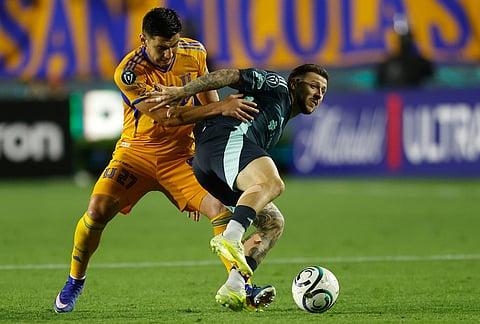 Jesus Angulo of Mexico's Tigres, left, and Paul Arriola of the United States' Seattle Sounders vie for the ball during a CONCACAF Champions Cup quarterfinal first leg soccer match in Monterrey, Mexico.