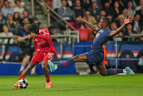 PSG's Nuno Mendes, right, challenges Liverpool's Jeremie Frimpong during the Champions League quarterfinal first leg soccer match between Paris Saint-Germain and Liverpool in Paris.