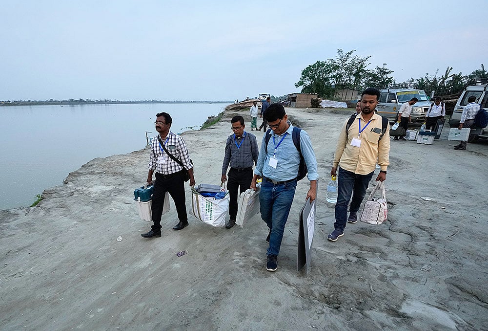 Assembly elections voting-Polling officials carry voting machines