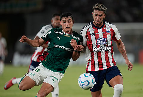 Ramon Sosa of Brazil's Palmeiras (19) and Daniel Rivera of Colombia's Junior battle for the ball during a Copa Libertadores Group F soccer match in Cartagena, Colombia.