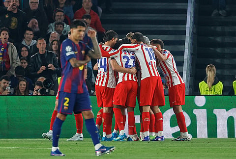 Atletico Madrid players celebrate after Atletico Madrid's Julian Alvarez scored his side's opening goal during the Champions League quarterfinal first leg soccer match between Barcelona and Atletico Madrid in Barcelona, Spain.